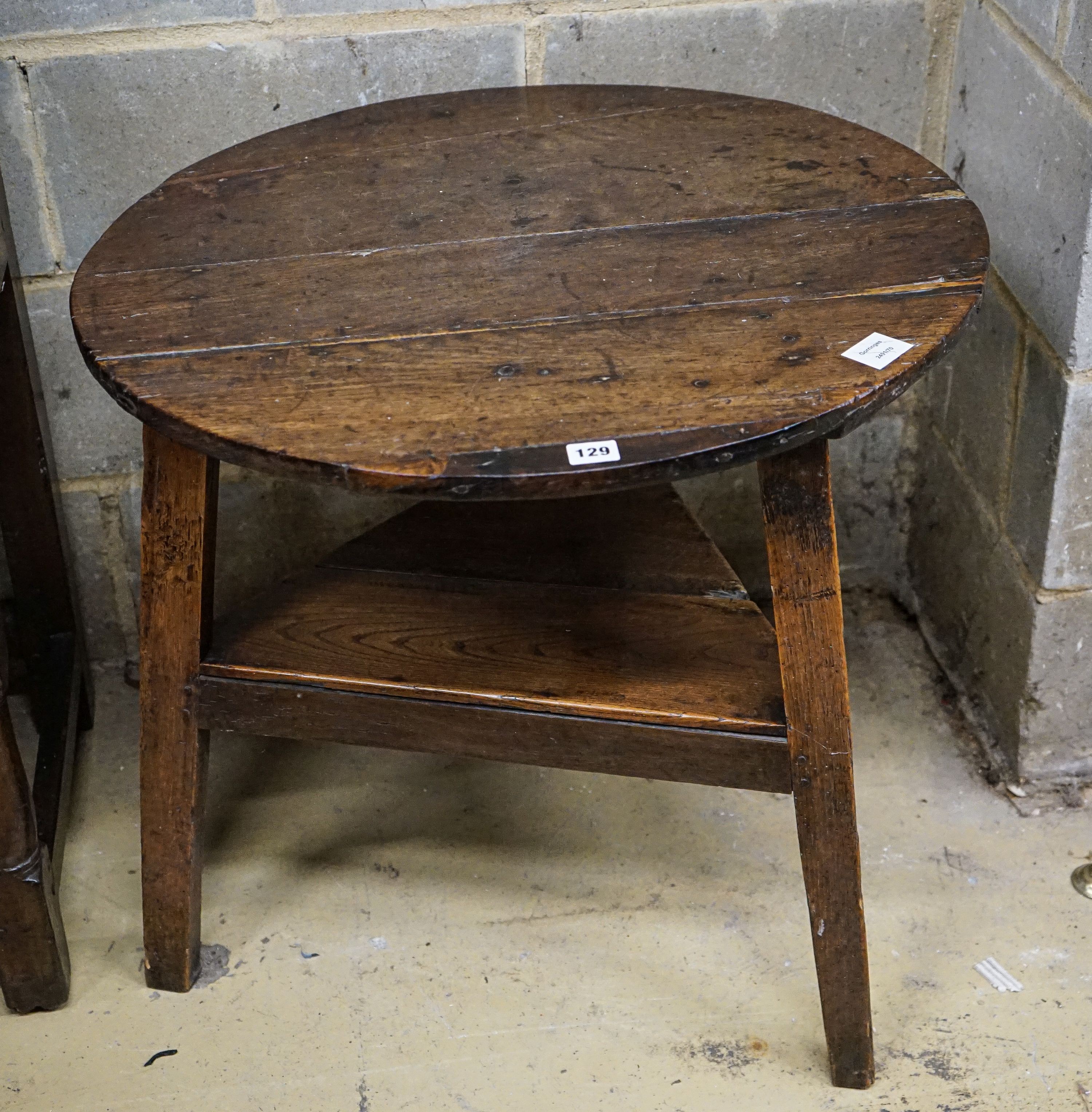 A George III oak cricket table, with circular top and triangular understage, diameter 67cm, height 65cm